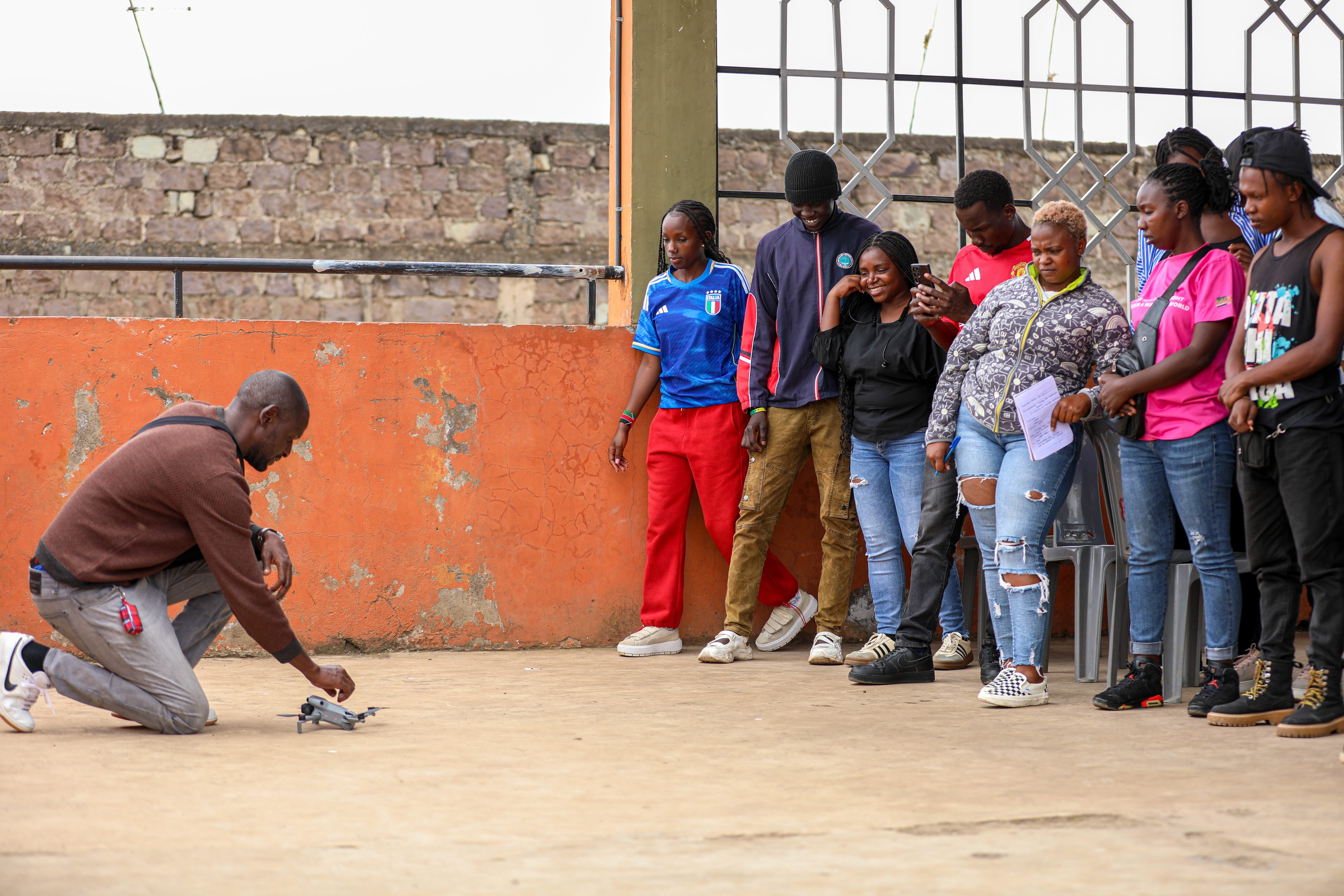 Michael Osunga Otieno, HOT's Geospatial Information Systems and Remote Sensing Specialist, leads a drone practical training session with community youth, Nairobi, March 2025. | Photo: HOT / SDI Kenya