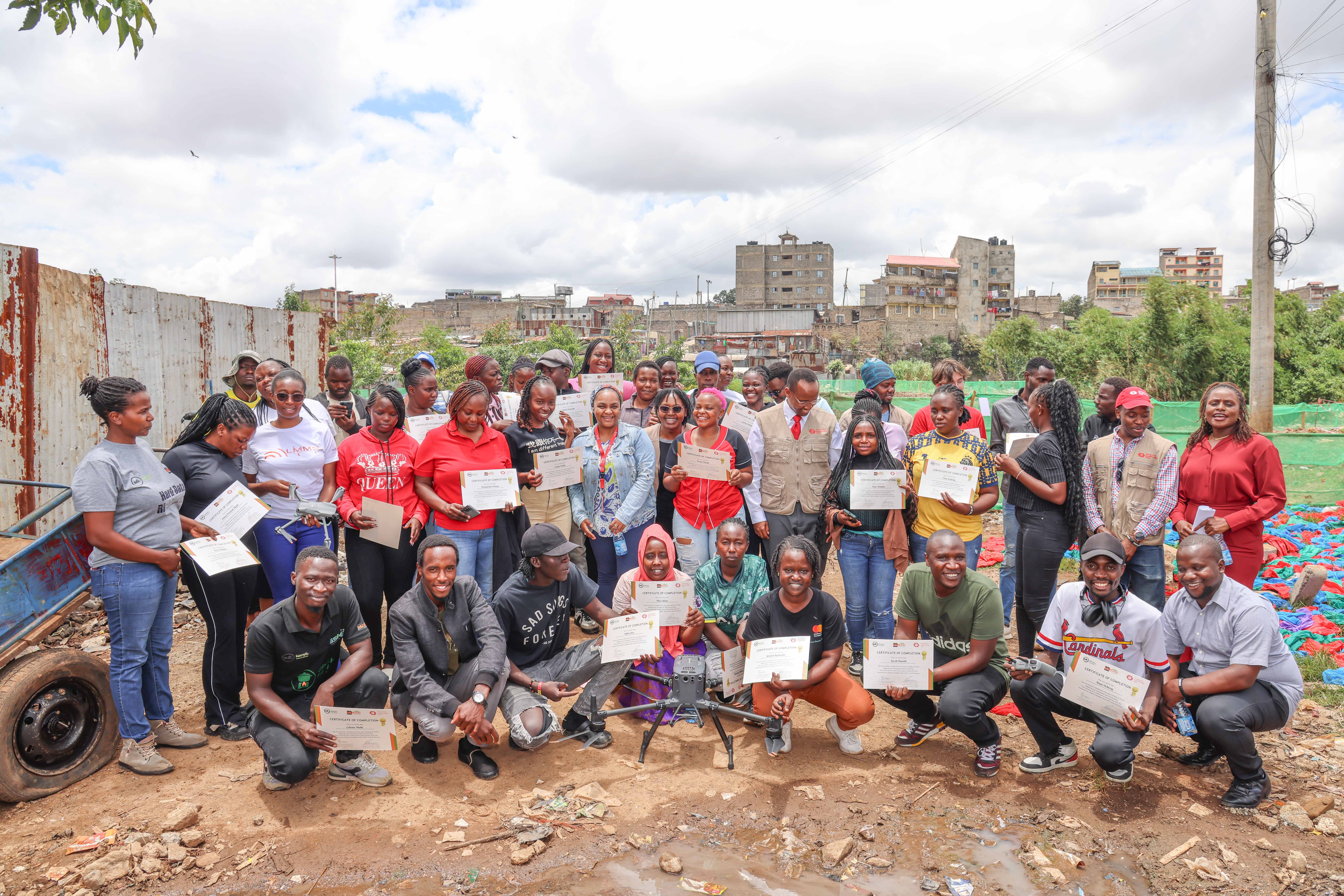 SDI Kenya team members join HOT staff in presenting certificates to community youth at the KYC Nairobi certification ceremony, Mathare, March 2025. | Photo: HOT / SDI Kenya