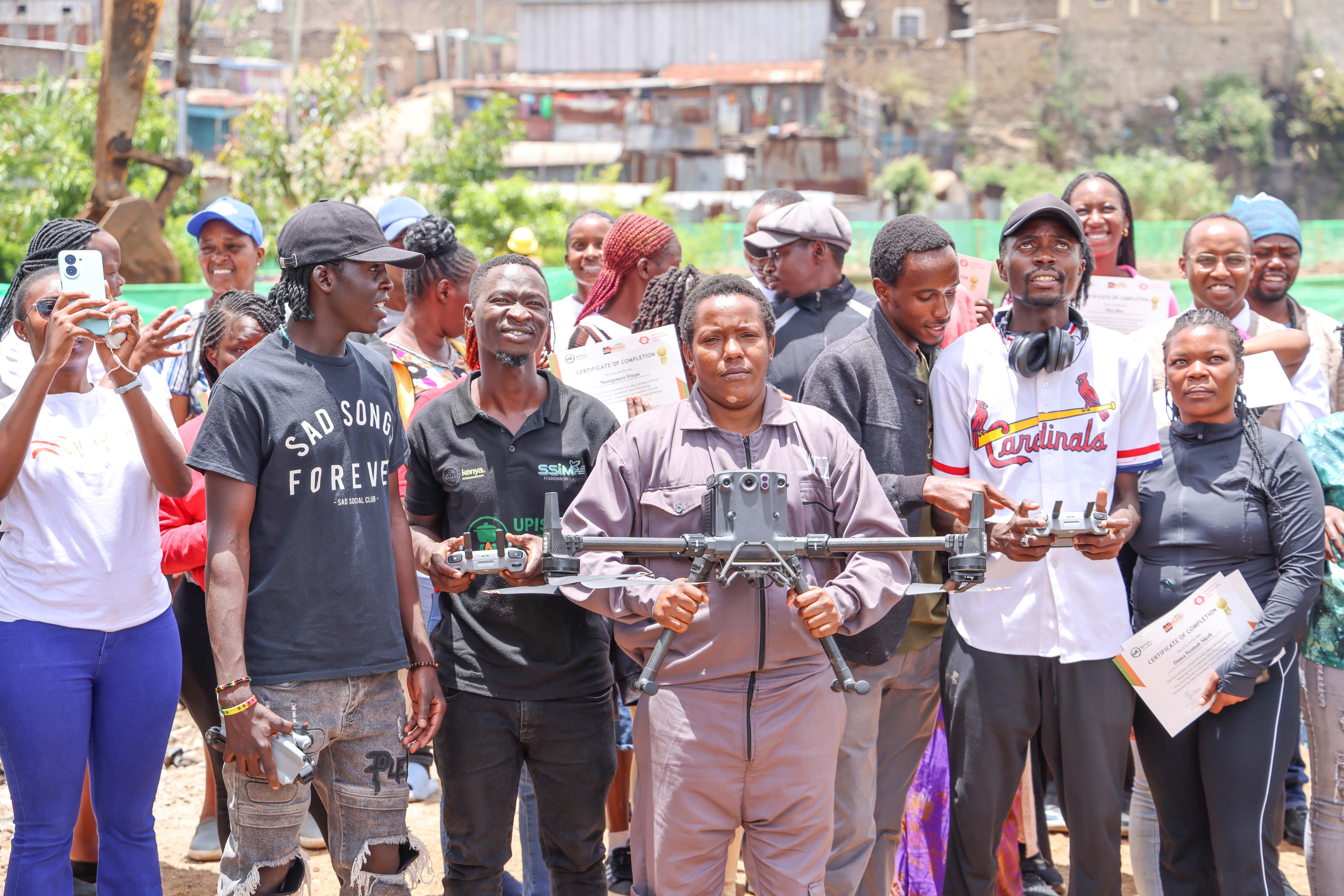Community youth practise drone operations under the guidance of HOT's Michael Osunga Otieno during the KYC Nairobi training, Nairobi, March 2025. | Photo: HOT / SDI Kenya