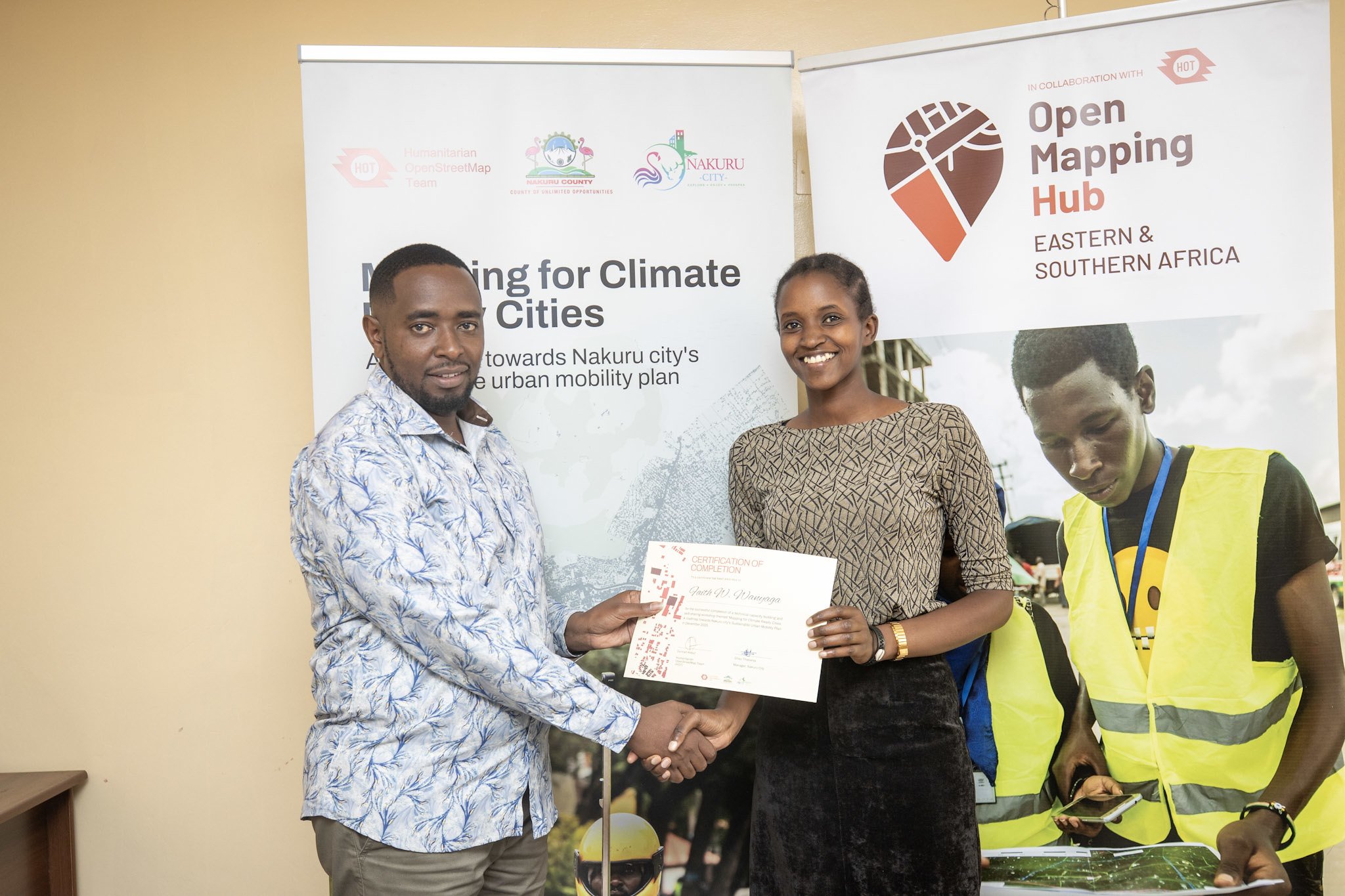 Youth mappers receiving certificates from City Manager Gitau Thabanja